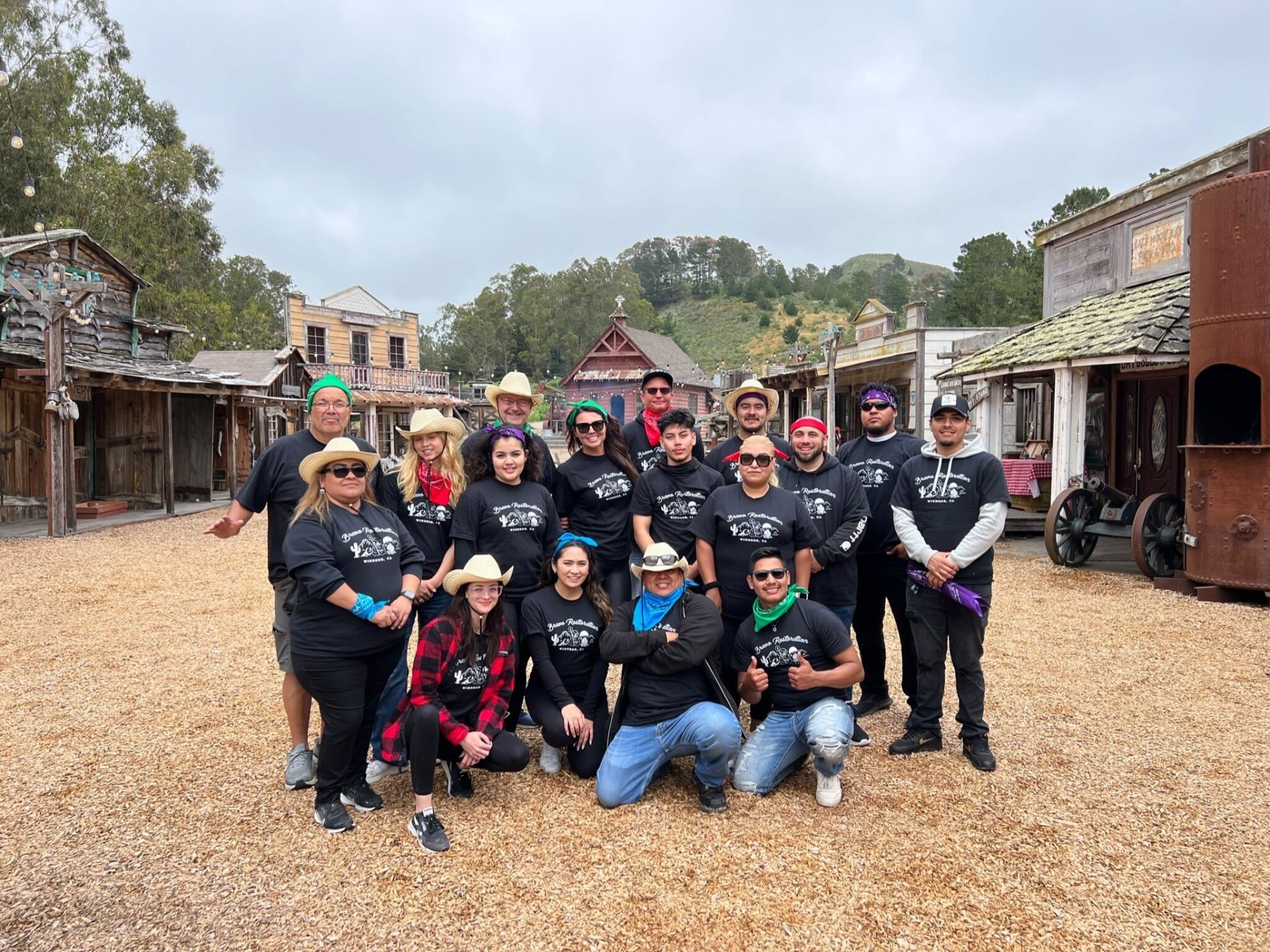 Bravo Restoration experts posing in front of an old western town after successfully completing fire damage remediation and smoke damage remediation.