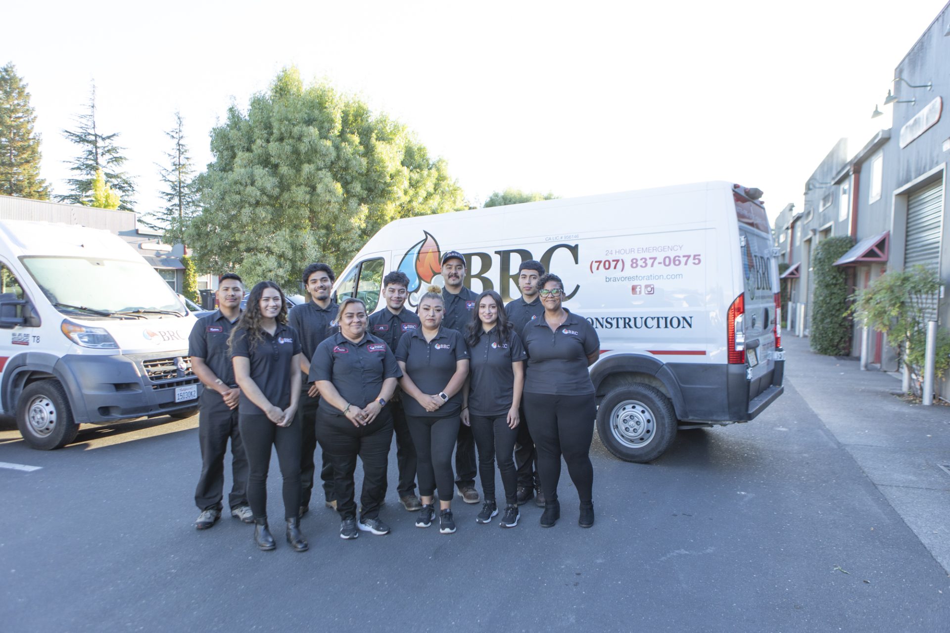 A group of bravo restoration experts standing in front of a van.