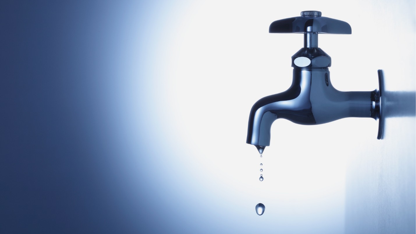 A Water Faucet That is Leaking Droplets Of Water From It